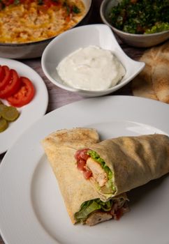 Lebanese recipe of chich taouk, garlic cream, toum, in a Lebanese bread, tabbouleh and chickpea puree, hummus High quality photo