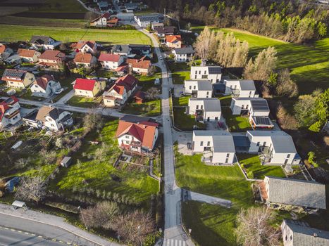 Drone view, aerial shoot of new build houses in the suburbs of Slovenia, somewhere in the country side, Europe. New modern houses, family homes.