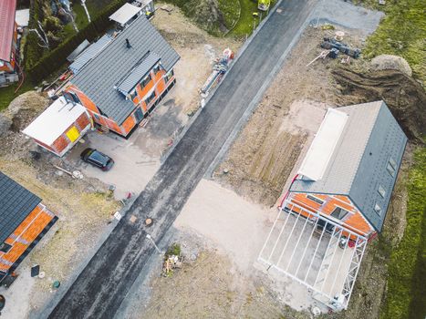 Drone view, aerial shoot of new build houses in the suburbs of Slovenia, somewhere in the country side, Europe. New modern houses, family homes.