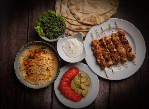 Lebanese recipe of chich taouk, garlic cream, toum, in a Lebanese bread, tabbouleh and chickpea puree, hummus High quality photo