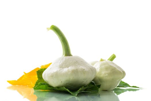 fresh organic squash with flowers and foliage isolated on white background