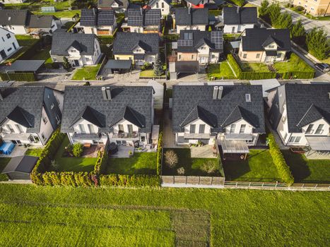 Drone view, aerial shoot of new build houses in the suburbs of Slovenia, somewhere in the country side, Europe. New modern houses, family homes.