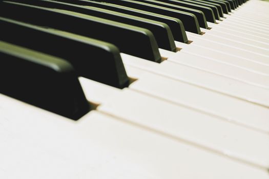 a set of keys on a piano or similar musical instrument. White and black musical keys of piano synthesizer with space for text.