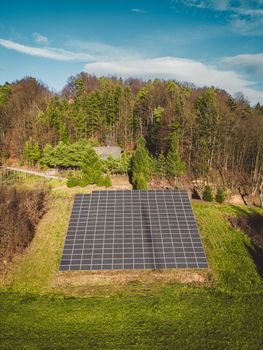 Aerial view of solar panels. Drone point of view, flying over a hill in the countryside in solar panels.