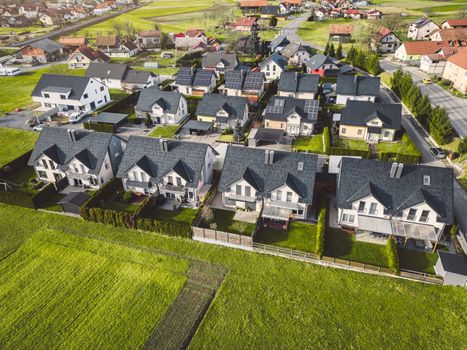 Drone view, aerial shoot of new build houses in the suburbs of Slovenia, somewhere in the country side, Europe. New modern houses, family homes.