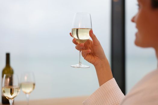 Woman drinking white wine from glass closeup. Anniversary celebration concept
