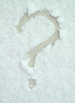 Question mark painted on white snow closeup. Changeable air temperature in winter concept