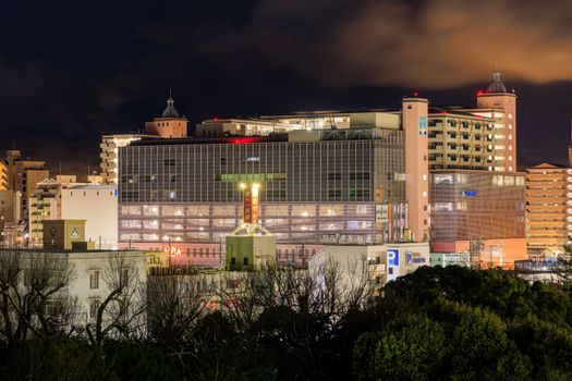 Large shopping mall and apartment buildings in city center at night. High quality photo