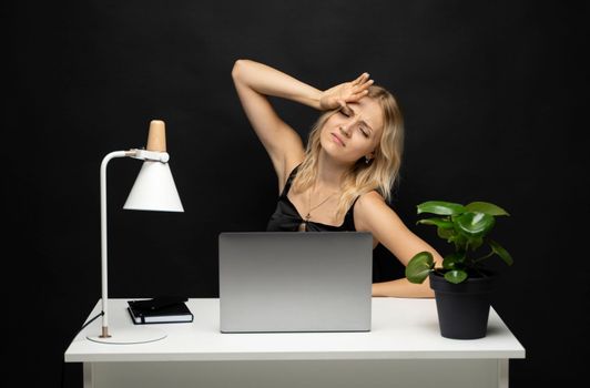 Frustrated unhappy laptop user woman touching head at work table with computer, going through stress, fatigue, burnout, getting bad news. Sad employee having problems with computer