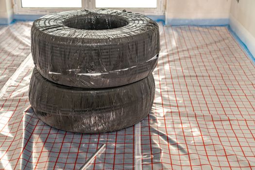 roll with pipe for underfloor heating in a new building. High quality photo