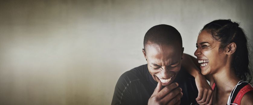 Fitness, mockup or laughter with a black couple in studio on a gray background for health and humor. Exercise, mock up or funny with a man and woman athlete laughing against a wall in the gym.