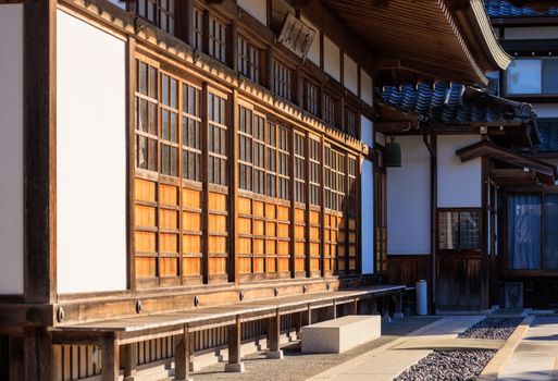 Morning sun on traditional sliding wooden doors at Japanese temple. High quality photo