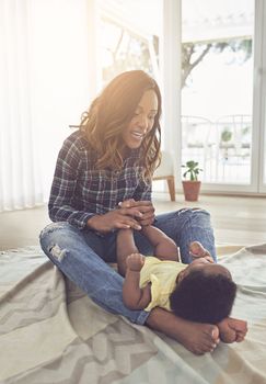 Spending the day with her daughter. Full length shot of a young mother and her little baby girl at home