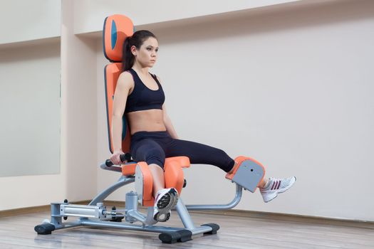 Full length portrait of athletic young woman in gym