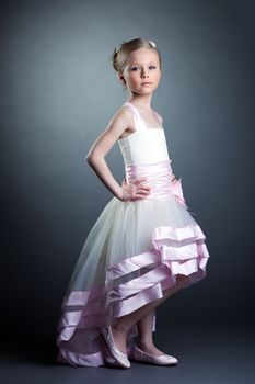 Studio portrait of pretty little girl in dress