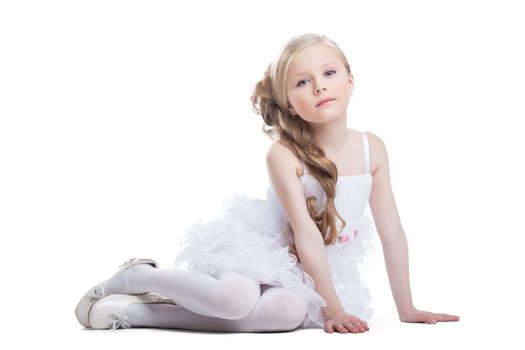 Portrait of sitting pretty girl in white dress, isolated on white