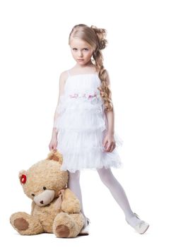 Full length portrait of sad little girl with soft toy. Isolated on white