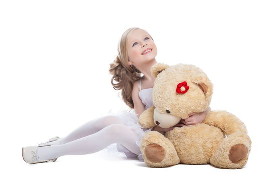 Beautiful little girl hugging big teddy bear, isolated on white