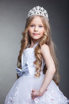 Studio portrait of pretty little girl in tiara