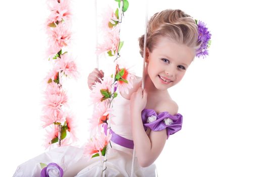 Portrait of beautiful girl on floral swing, on white background