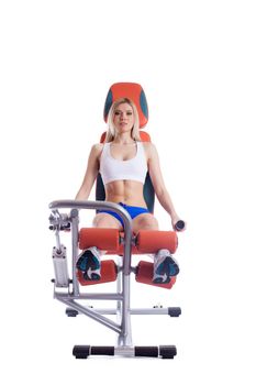 Blonde woman sitting on orange hydraulic exerciser. Isolated on white