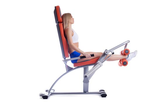 Beautiful woman sitting on orange hydraulic exerciser. Isolated on white