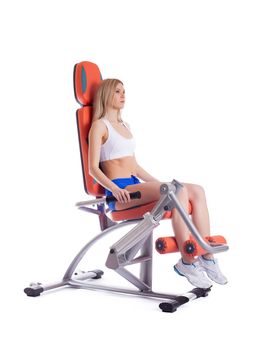 Full length portrait of blonde young woman on exerciser. Isolated on white