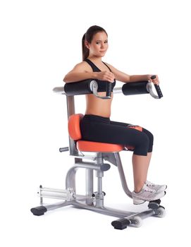 Full length portrait of brunette young woman on exerciser. Isolated on white