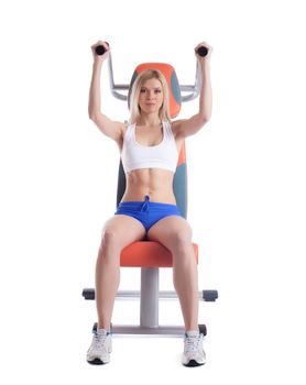 Beautiful blonde on power exerciser isolated on white