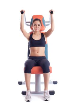 Brunette woman sitting on orange hydraulic exerciser. Isolated on white