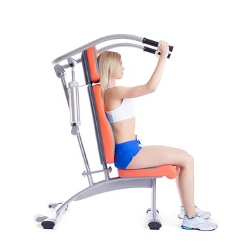 Young woman sitting on orange hydraulic exerciser. Isolated on white
