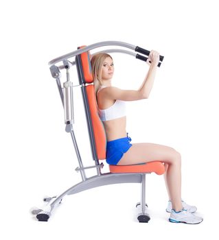 Young woman sitting on exerciser. Isolated on white