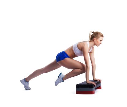 Slim young woman with stepper. Isolated on white