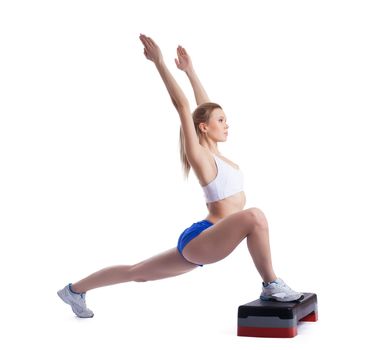 Young blonde woman with stepper. Isolated on white