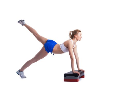 Young fitness woman with stepper. Isolated on white