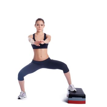 Fitness brunette woman with stepper. Isolated on white