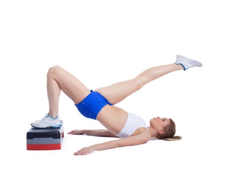 Fitness blonde woman with stepper. Isolated on white