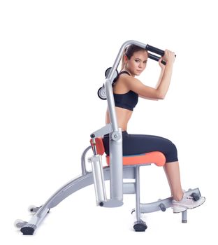 Brunette woman posing on orange hydraulic exerciser. Isolated on white