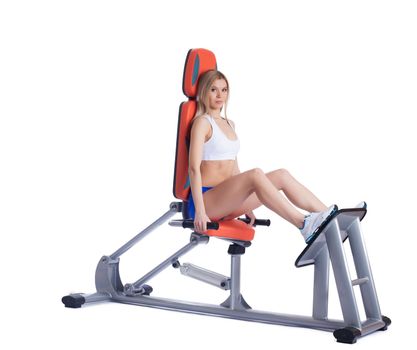 Blonde young woman sitting on isodynamic exerciser. Isolated on white
