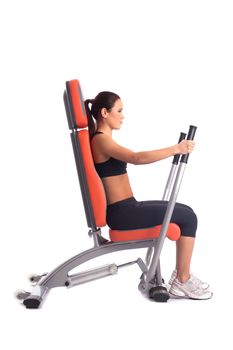 Brunette young woman on hydraulic exerciser. Isolated on white