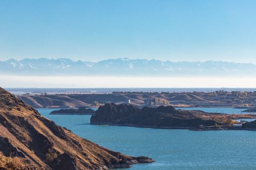 Lake Kapchagai near the city of Konaev against the backdrop of mountains in Kazakhstan, Almaty region.