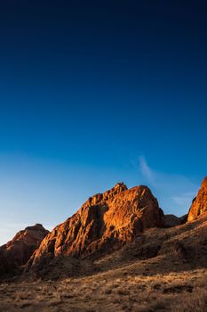 Sunrise rocky picturesque landscape near the Ili River in the Almaty region of Kazakhstan. Copy space, vertical.