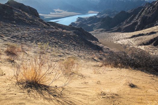 View from afar of the river in the arid steppe of Kazakhstan Ili, landscape of central asia.