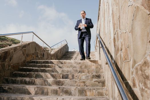 Business executive with briefcase going down the stairs.