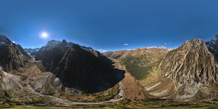 panoramic shot of a mountain range in summer on a sunny cloudless day. bare rocky cliffs.