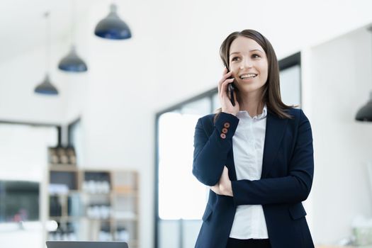 business owner or Asian female marketers are using business phones in office work.