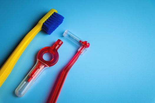 Dental hygiene. Toothbrush, hygienic brushes on a blue background. flat top view.