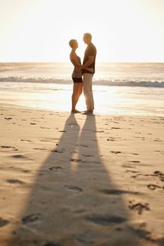 Romance at sunset. a mature couple enjoying a day at the beach
