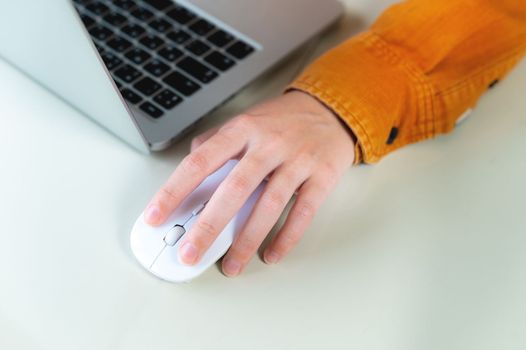 Close-up woman searching and clicking mouse using laptop, online shopping concept. Blurred background, vertical shot