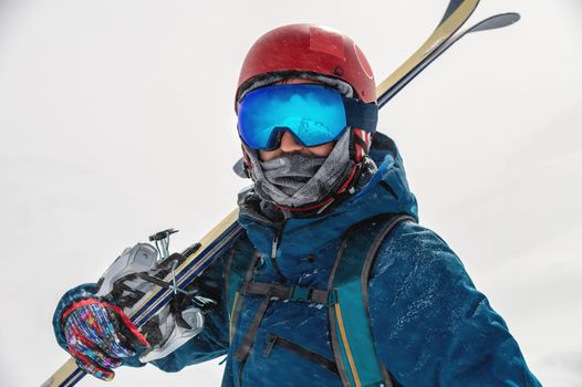 Young man on a ski vacation in the mountains, portrait. Great rider holiday in ski resort.